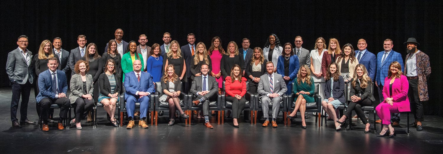 A group of forty community leaders posing for a photo.