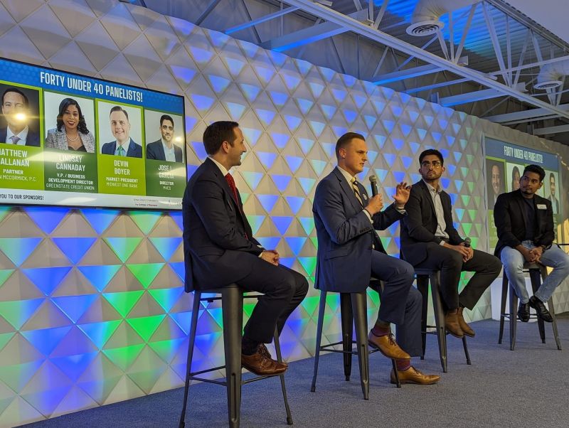 Four people giving an informational lecture on stage.